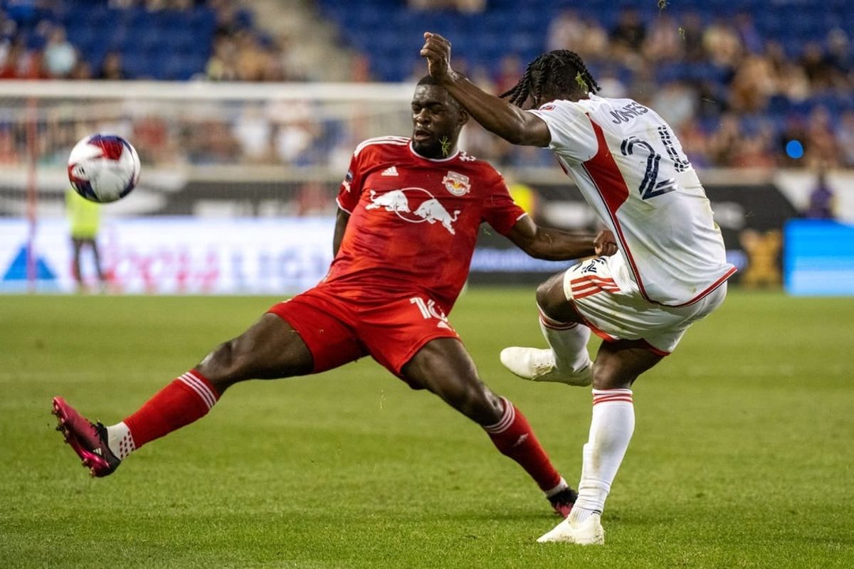 Jul 22, 2023; Harrison, NJ, USA; New York Red Bulls midfielder Dru Yearwood (16) blocks a pass by New England Revolution forward DeJuan Jones (24) during the second half at Red Bull Arena.