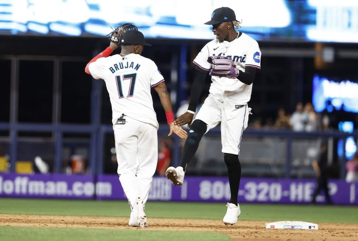 Apr 16, 2024; Miami, Florida, USA;  Miami Marlins shortstop Vidal Brujan (17) outfielder Nick Gordon (1) celebrate after defeating the San Francisco Giants at loanDepot Park.