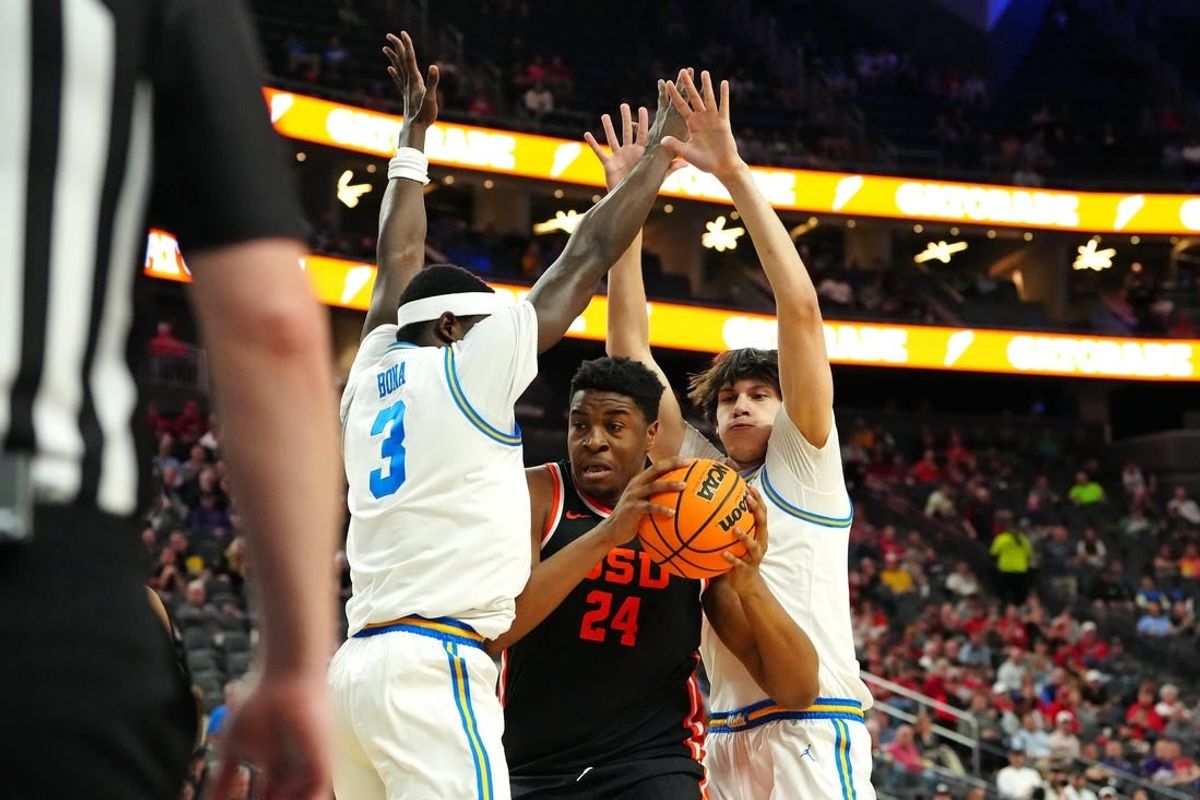 Mar 13, 2024; Las Vegas, NV, USA; Oregon State Beavers center KC Ibekwe (24) looks to shoot between UCLA Bruins forward Adem Bona (3) and UCLA Bruins forward Berke Buyuktuncel (9) during the first half at T-Mobile Arena.