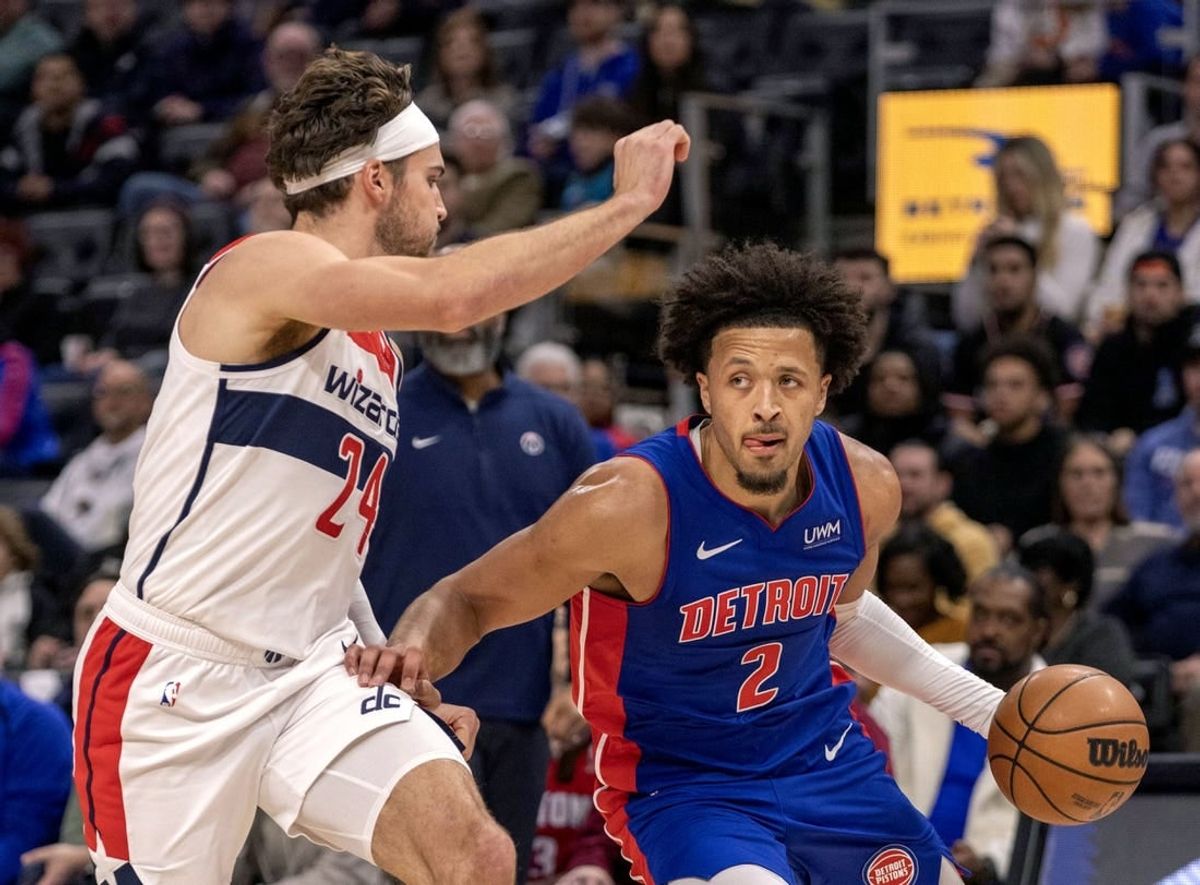 Nov 27, 2023; Detroit, Michigan, USA; Washington Wizards forward Corey Kispert (24) defends against Detroit Pistons guard Cade Cunningham (2) during the in the first half at Little Caesars Arena.