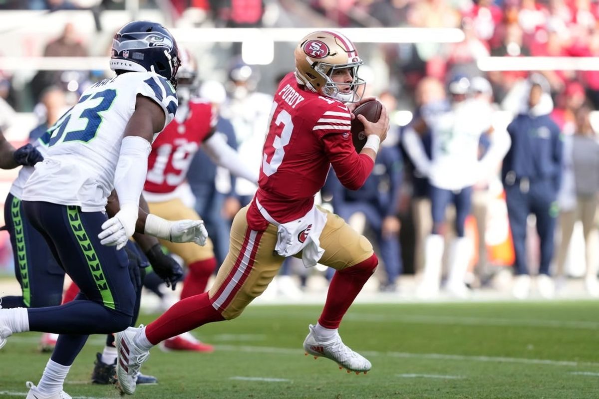 Dec 10, 2023; Santa Clara, California, USA; San Francisco 49ers quarterback Brock Purdy (13) carries the ball against the Seattle Seahawks during the second quarter at Levi's Stadium.
