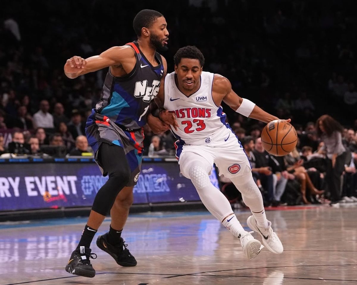 Apr 6, 2024; Brooklyn, New York, USA; Detroit Pistons point guard Jaden Ivey (23) dribbles the ball against Brooklyn Nets small forward Mikal Bridges (1) during the first half at Barclays Center.