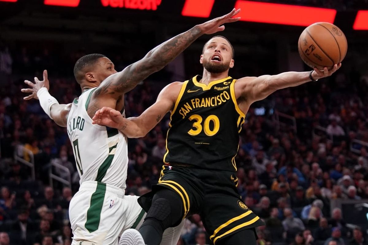 Mar 6, 2024; San Francisco, California, USA; Golden State Warriors guard Stephen Curry (30) shoots the ball while being defended by Milwaukee Bucks guard Damian Lillard (0) in the third quarter at the Chase Center.