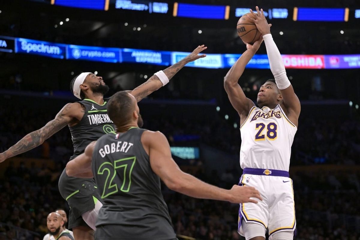 Apr 7, 2024; Los Angeles, California, USA;  Los Angeles Lakers forward Rui Hachimura (28) is defended by Minnesota Timberwolves guard Nickeil Alexander-Walker (9) and center Rudy Gobert (27) in the first half at Crypto.com Arena.