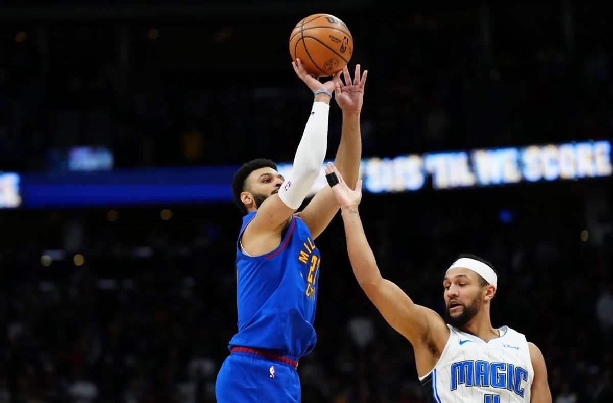 Jan 5, 2024; Denver, Colorado, USA; Denver Nuggets guard Jamal Murray (27) shoots over Orlando Magic guard Jalen Suggs (4) in the first quarter at Ball Arena.