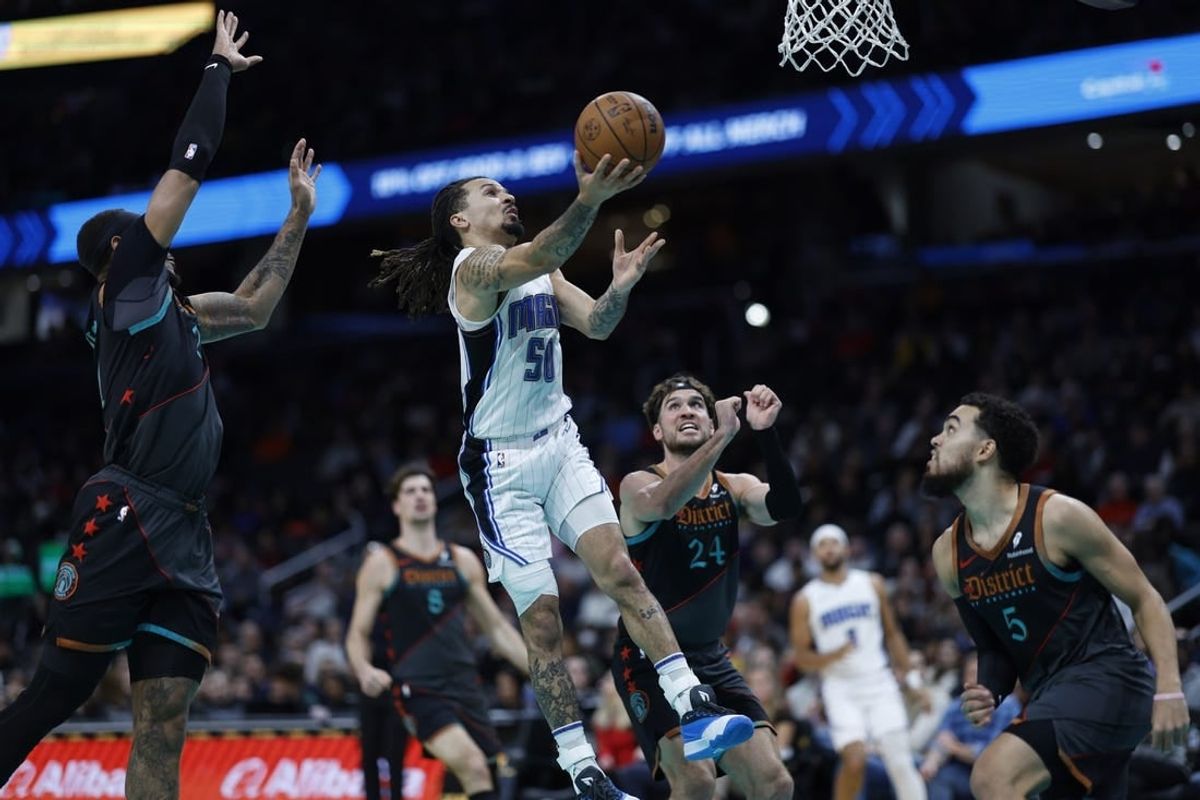 Dec 26, 2023; Washington, District of Columbia, USA; Orlando Magic guard Cole Anthony (50) shoots the ball as Washington Wizards center Daniel Gafford (21) defends in the second quarter at Capital One Arena.