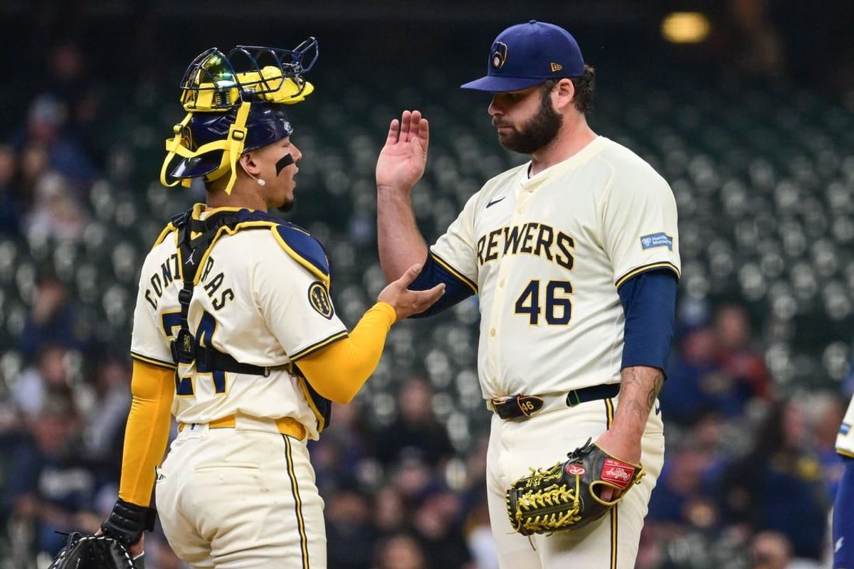 Apr 17, 2024; Milwaukee, Wisconsin, USA;  Milwaukee Brewers pitcher Bryse Wilson (46) exchange a handshake with catcher William Contreras (24) during a pitching change in the fourth inning against the San Diego Padres at American Family Field.
