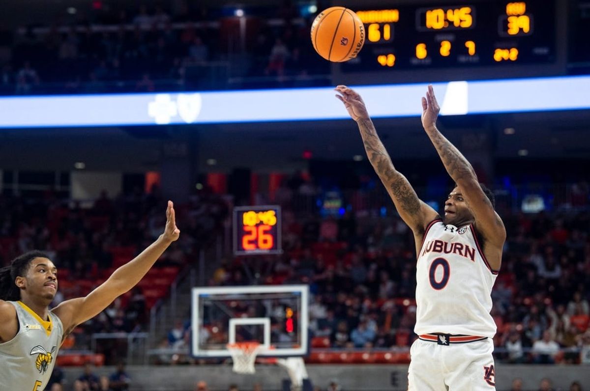 Auburn Tigers guard K.D. Johnson (0) shoots a three-pointer as Auburn Tigers take on Alabama State Hornets at Neville Arena in Auburn, Ala., on Friday, Dec. 22, 2023. Auburn Tigers defeated Alabama State Hornets 82-62.