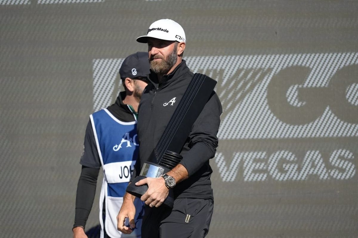 Feb 10, 2024; Las Vegas, Nevada, USA; Dustin Johnson holds the individual championship trophy after winning the LIV Golf Las Vegas tournament at Las Vegas Country Club.