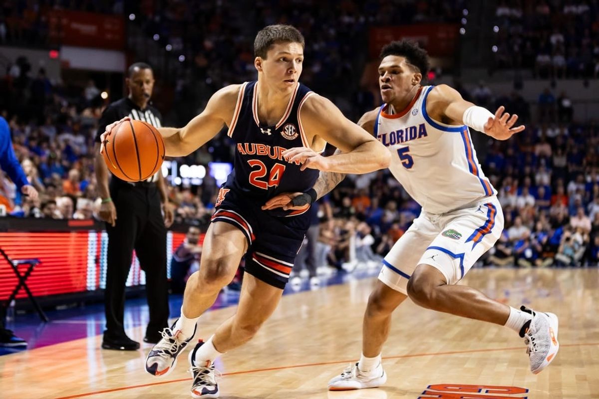 Feb 10, 2024; Gainesville, Florida, USA; Auburn Tigers guard Lior Berman (24) drives to the basket against Florida Gators guard Will Richard (5) during the first half at Exactech Arena at the Stephen C. O'Connell Center.