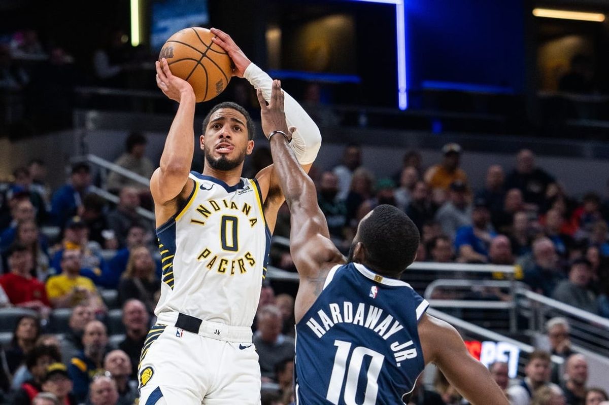 Feb 25, 2024; Indianapolis, Indiana, USA; Indiana Pacers guard Tyrese Haliburton (0) shoots the ball while Dallas Mavericks forward Tim Hardaway Jr. (10) defends in the first half at Gainbridge Fieldhouse.