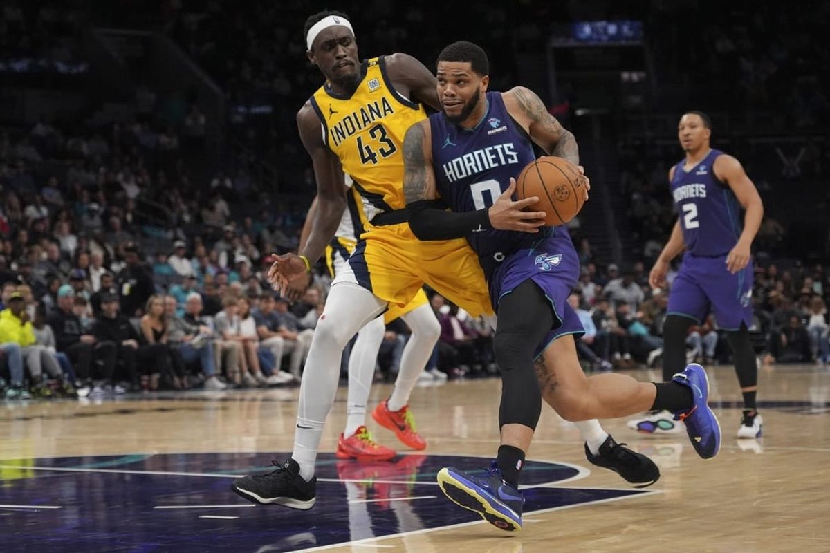 Feb 12, 2024; Charlotte, North Carolina, USA; Charlotte Hornets forward Miles Bridges (0) drives to the basket guarded by Indiana Pacers forward Pascal Siakam (43) during the second half at Spectrum Center.