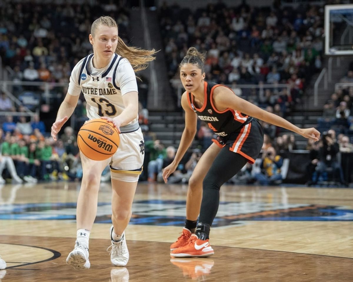 Mar 29, 2024; Albany, NY, USA; Notre Dame Fighting Irish guard Anna DeWolfe (13) dribbles the ball past Oregon State Beavers guard Donovyn Hunter (4) during the first half in the semifinals of the Albany Regional of the 2024 NCAA Tournament at the MVP Arena at MVP Arena.
