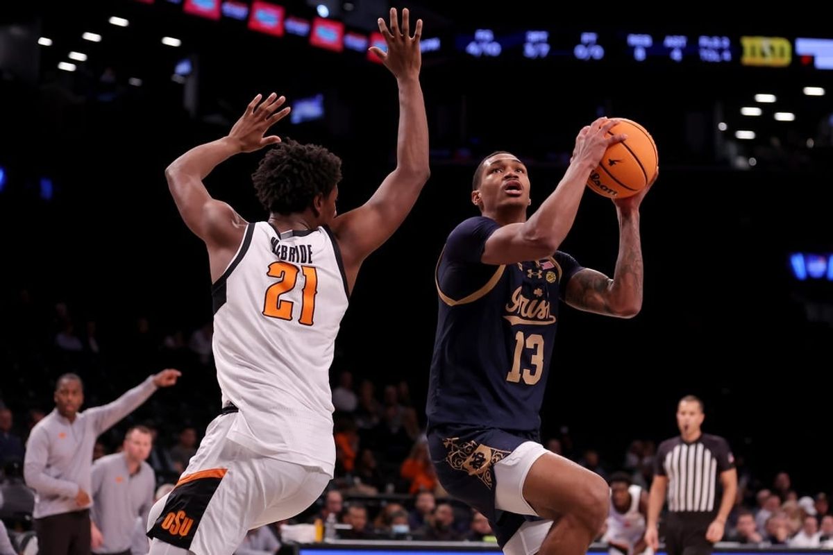 Nov 17, 2023; Brookyln, NY, USA; Notre Dame Fighting Irish forward Tae Davis (13) looks to shoot the ball against Oklahoma State Cowboys forward Justin McBride (21) during the first half at Barclays Center.