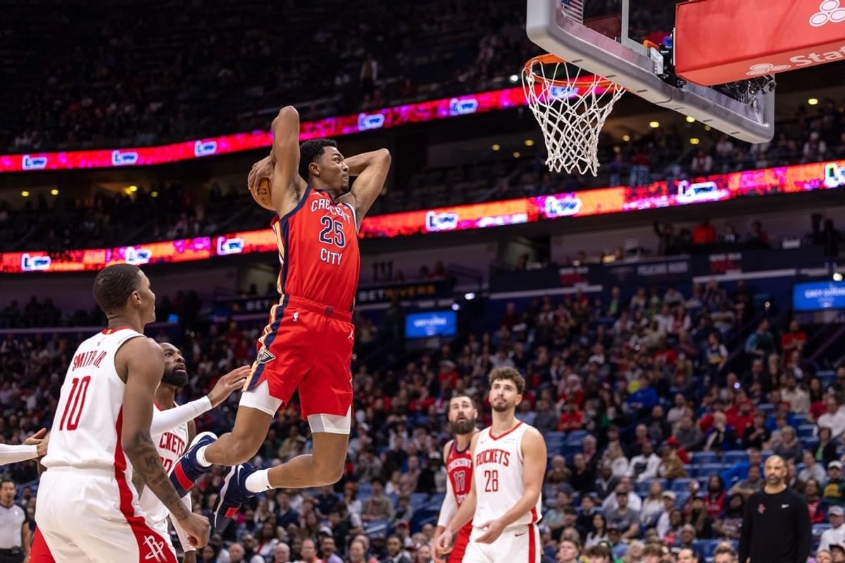 Dec 23, 2023; New Orleans, Louisiana, USA;  New Orleans Pelicans guard Trey Murphy III (25) dunks against Houston Rockets forward Jabari Smith Jr. (10) during the first half at Smoothie King Center.