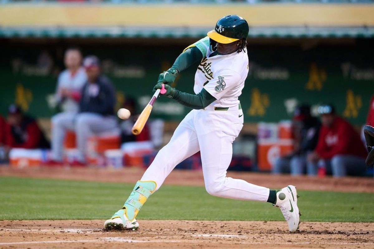 Apr 12, 2024; Oakland, California, USA; Oakland Athletics outfielder Lawrence Butler (4) hits a one run home run against the Washington Nationals during the third inning at Oakland-Alameda County Coliseum.