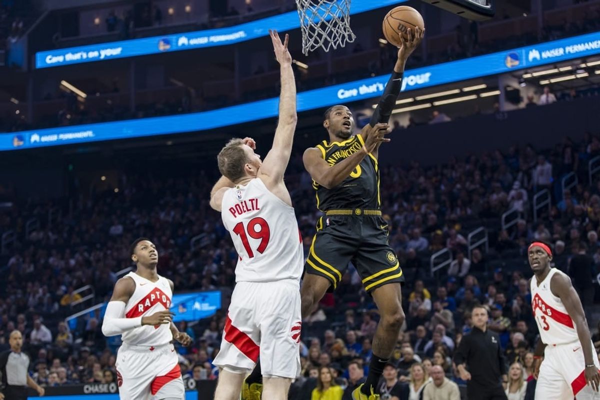 Jan 7, 2024; San Francisco, California, USA;  Toronto Raptors center Jakob Poeltl (19) defends against a shot by Golden State Warriors forward Jonathan Kuminga (00)  during the first half at Chase Center.