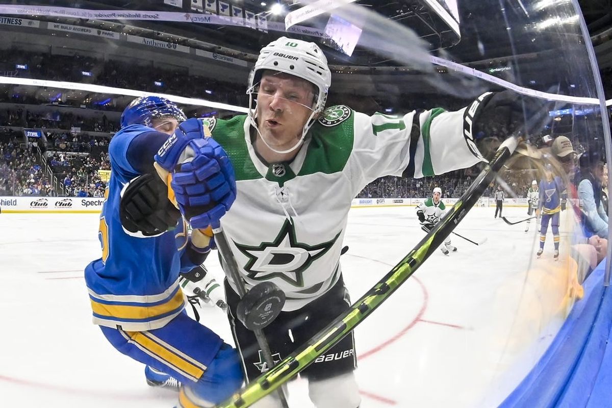 Dec 16, 2023; St. Louis, Missouri, USA;  Dallas Stars center Ty Dellandrea (10) and St. Louis Blues defenseman Tyler Tucker (75) battle for the puck during the first period at Enterprise Center.