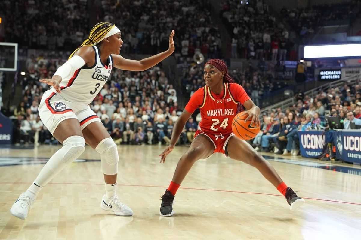 Nov 16, 2023; Storrs, Connecticut, USA; Maryland Terrapins guard Bri McDaniel (24) dribbles the ball against Connecticut Huskies forward Aaliyah Edwards (3) during the first half at Harry A. Gampel Pavilion.