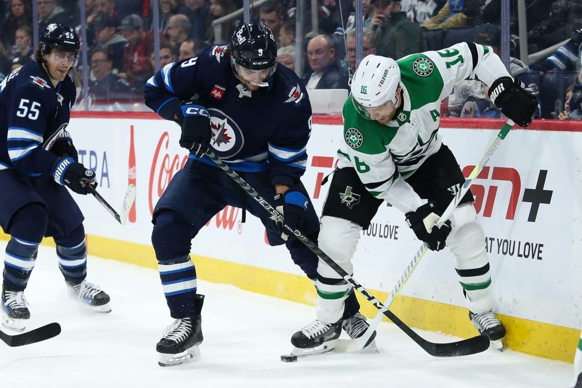 Nov 11, 2023; Winnipeg, Manitoba, CAN;  Winnipeg Jets forward Alex Iafallo (9) battles Dallas Stars forward Joe Pavelski (16) for the puck during the second period at Canada Life Centre.
