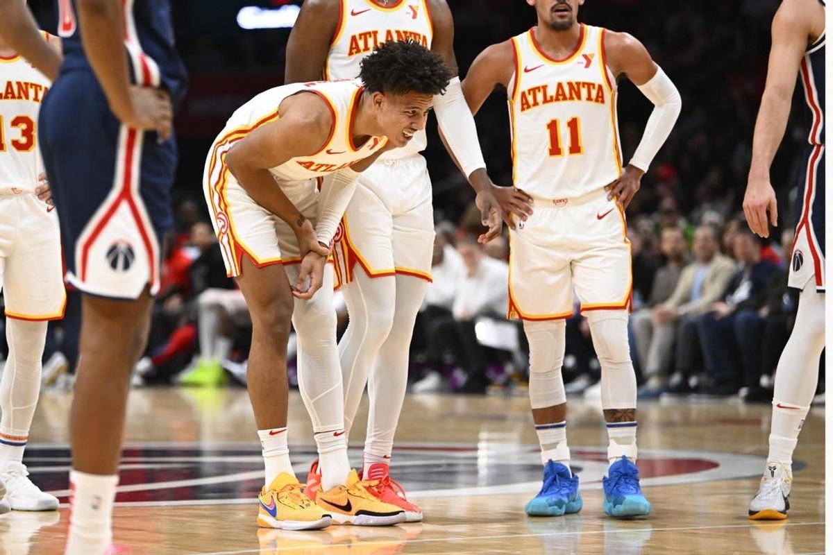 Nov 25, 2023; Washington, District of Columbia, USA; Atlanta Hawks forward Jalen Johnson (1) grabs his arm after suffering an apparent injury against the Washington Wizards during the first half at Capital One Arena.