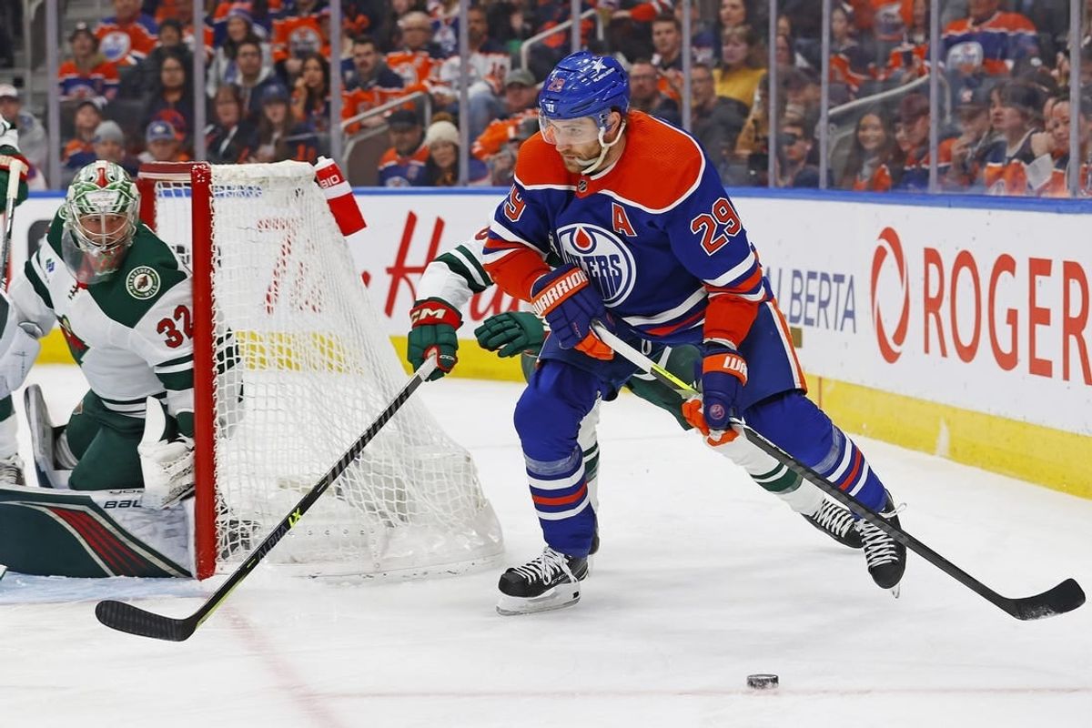 Feb 23, 2024; Edmonton, Alberta, CAN; Edmonton Oilers forward Leon Draisaitl (29) looks to make a pass in front of Minnesota Wild defensemen Dakota Mermis (6) during the first period at Rogers Place.