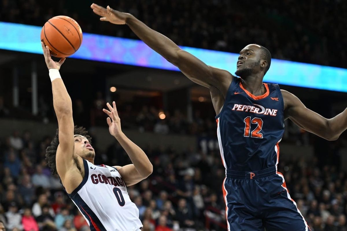 Jan 4, 2024; Spokane, Washington, USA; Gonzaga Bulldogs guard Ryan Nembhard (0) shoots the ball against Pepperdine Waves forward Boubacar Coulibaly (12) in the first half at Spokane Arena.