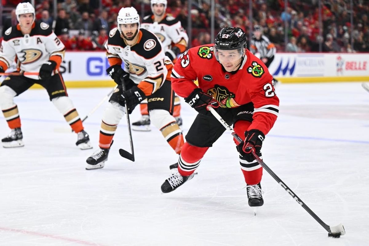 Dec 7, 2023; Chicago, Illinois, USA; Chicago Blackhawks forward Philipp Kurashev (23) skates the puck up the ice in the third period against the Anaheim Ducks at United Center.
