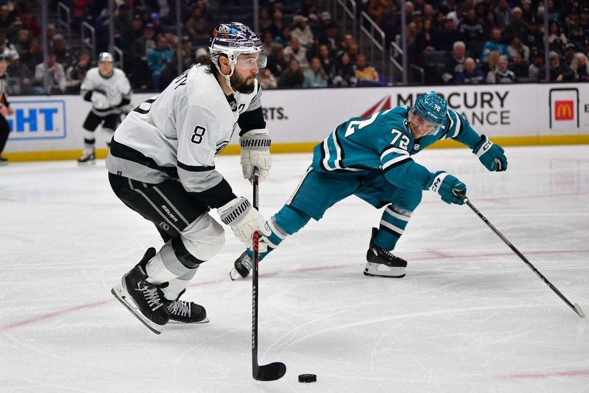 Jan 22, 2024; Los Angeles, California, USA; Los Angeles Kings defenseman Drew Doughty (8) moves the puck against San Jose Sharks left wing William Eklund (72) during the third period at Crypto.com Arena.