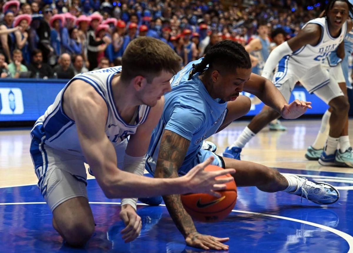Mar 9, 2024; Durham, North Carolina, USA; North Carolina Tar Heels forward Armando Bacot (5) grabs a loose ball from Duke Blue Devils center Kyle Filipowski (30) during the first half at Cameron Indoor Stadium.