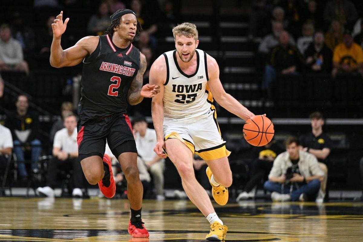 Nov 17, 2023; Iowa City, Iowa, USA; Iowa Hawkeyes forward Ben Krikke (23) controls the ball as Arkansas State Red Wolves guard Freddy Hicks (2) defends during the first half at Carver-Hawkeye Arena.