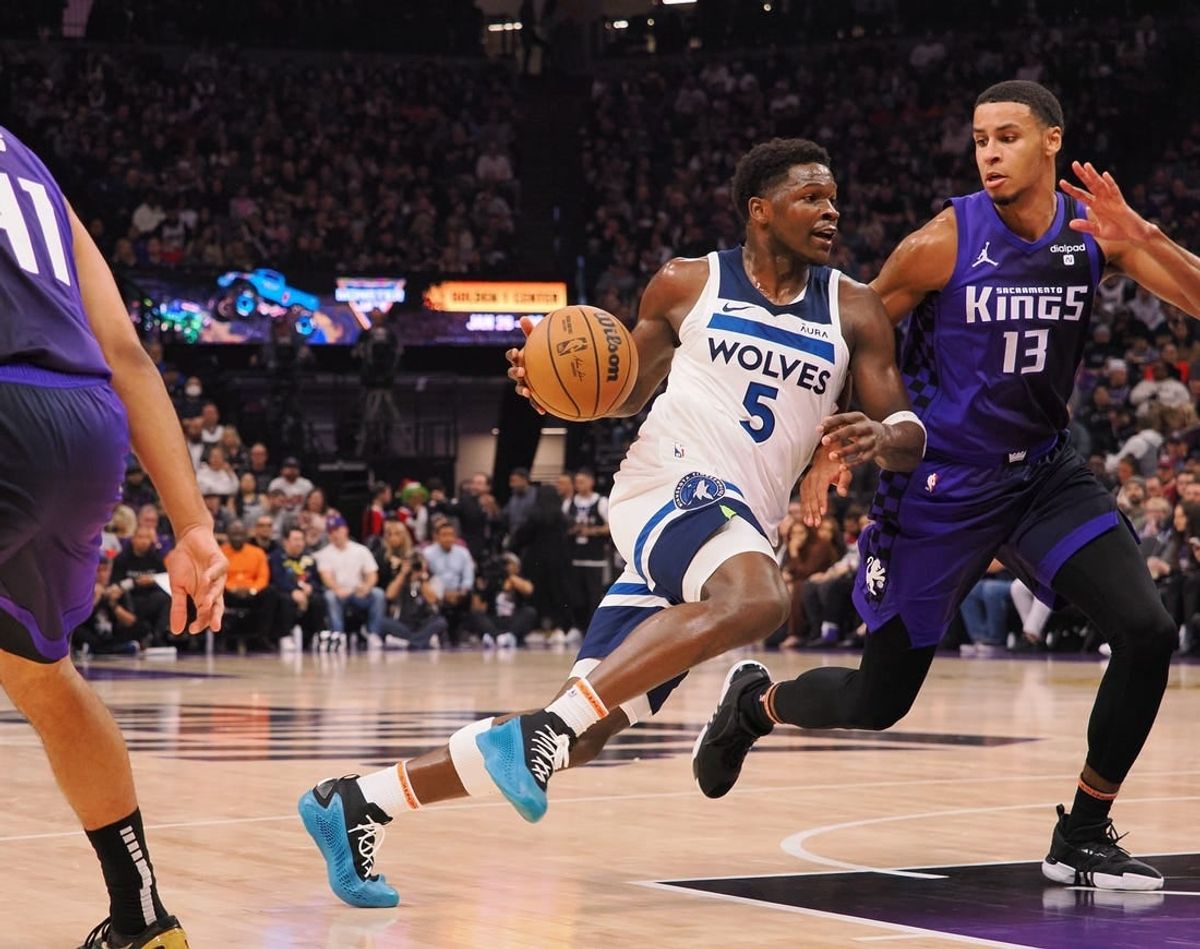 Dec 23, 2023; Sacramento, California, USA; Minnesota Timberwolves guard Anthony Edwards (5) drives in against Sacramento Kings forward Keegan Murray (13) during the first quarter at Golden 1 Center.
