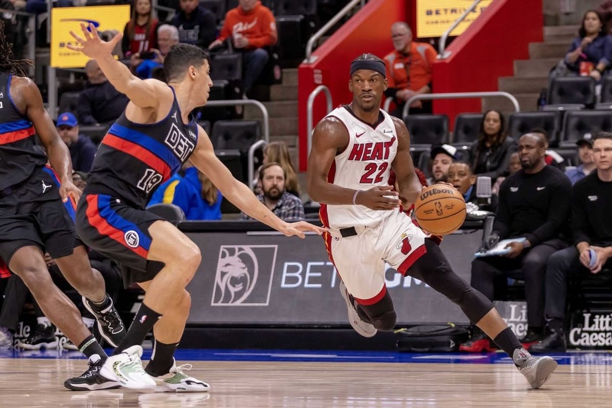 Mar 15, 2024; Detroit, Michigan, USA; Miami Heat forward Jimmy Butler (22) drives to the basket as Detroit Pistons forward Simone Fontecchio (19) defends during the first quarter at Little Caesars Arena.