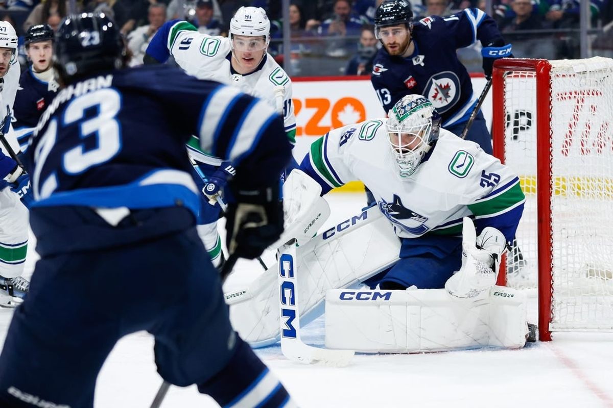 Apr 18, 2024; Winnipeg, Manitoba, CAN;  Vancouver Canucks goalie Thatcher Demko (35) watches Winnipeg Jets forward Sean Monahan (23) during the second period at Canada Life Centre.