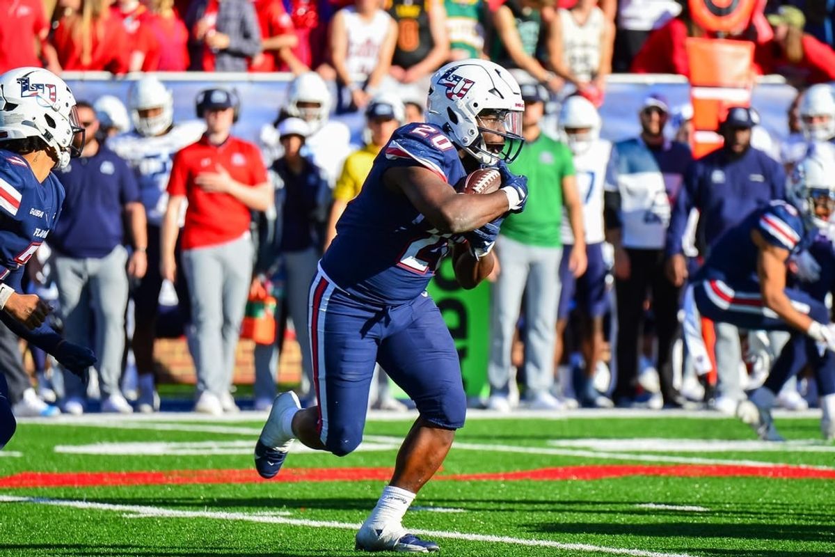 Nov 11, 2023; Lynchburg, Virginia, USA;  Liberty Flames running back Quinton Cooley (20) runs the ball in the third quarter at Williams Stadium.