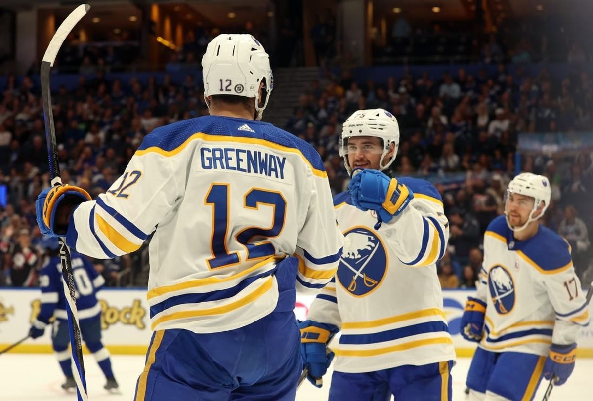 Apr 15, 2024; Tampa, Florida, USA; Buffalo Sabres left wing Jordan Greenway (12) is congratulated after he scored a goal against the Tampa Bay Lightning during the second period at Amalie Arena.