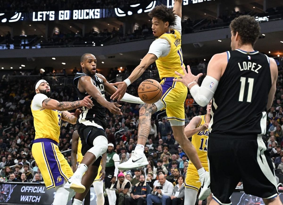 Mar 26, 2024; Milwaukee, Wisconsin, USA; Milwaukee Bucks forward Khris Middleton (22) drives tot the basket against Los Angeles Lakers center Jaxson Hayes (11) in the first half at Fiserv Forum.