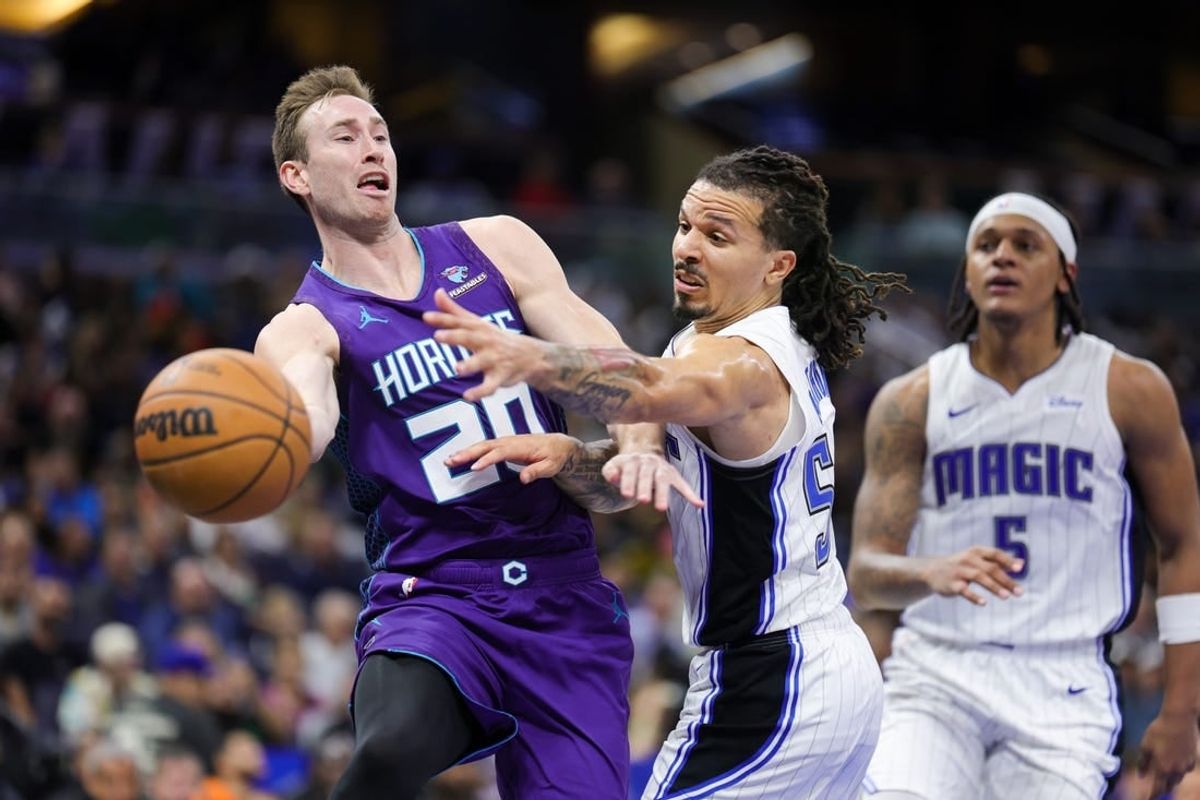 Nov 26, 2023; Orlando, Florida, USA;  Charlotte Hornets forward Gordon Hayward (20) passes the ball past Orlando Magic guard Cole Anthony (50) in the fourth quarter at Amway Center.