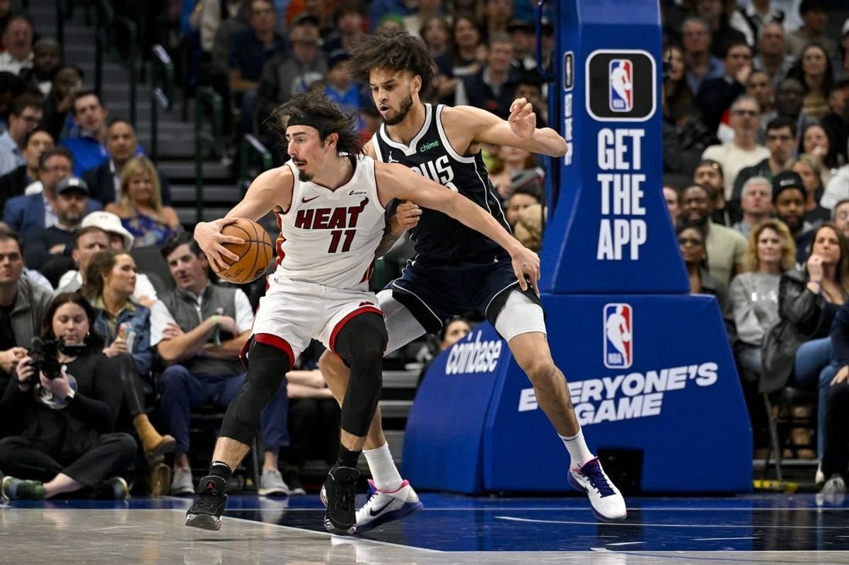 Mar 7, 2024; Dallas, Texas, USA; Miami Heat guard Jaime Jaquez Jr. (11) looks to move the ball past Dallas Mavericks center Dereck Lively II (2) during the second half at the American Airlines Center.