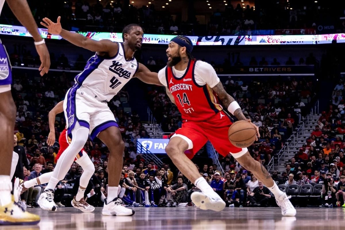 Apr 19, 2024; New Orleans, Louisiana, USA;  New Orleans Pelicans forward Brandon Ingram (14) dribbles against Sacramento Kings forward Harrison Barnes (40) in the first half during a play-in game of the 2024 NBA playoffs at Smoothie King Center.