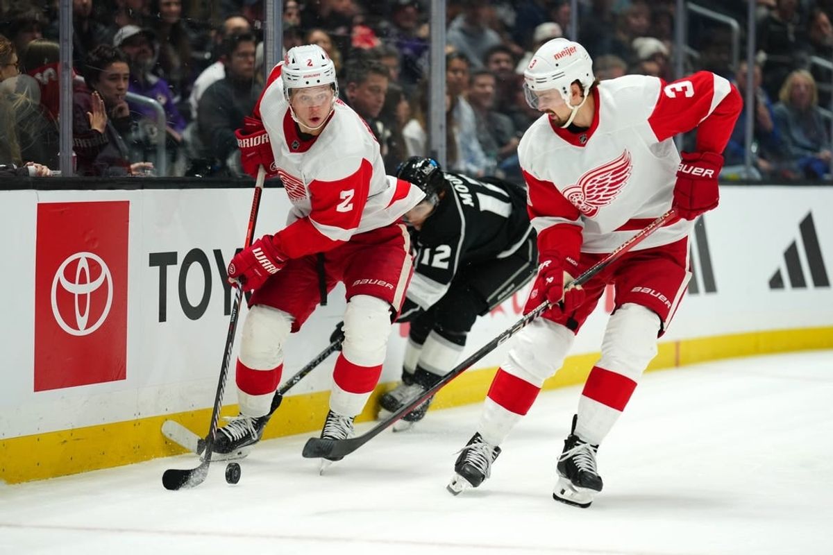 Jan 4, 2024; Los Angeles, California, USA; Detroit Red Wings defenseman Olli Maatta (2) and defenseman Justin Holl (3) battle for the puck with LA Kings left wing Trevor Moore (12) in the second period at Crypto.com Arena.