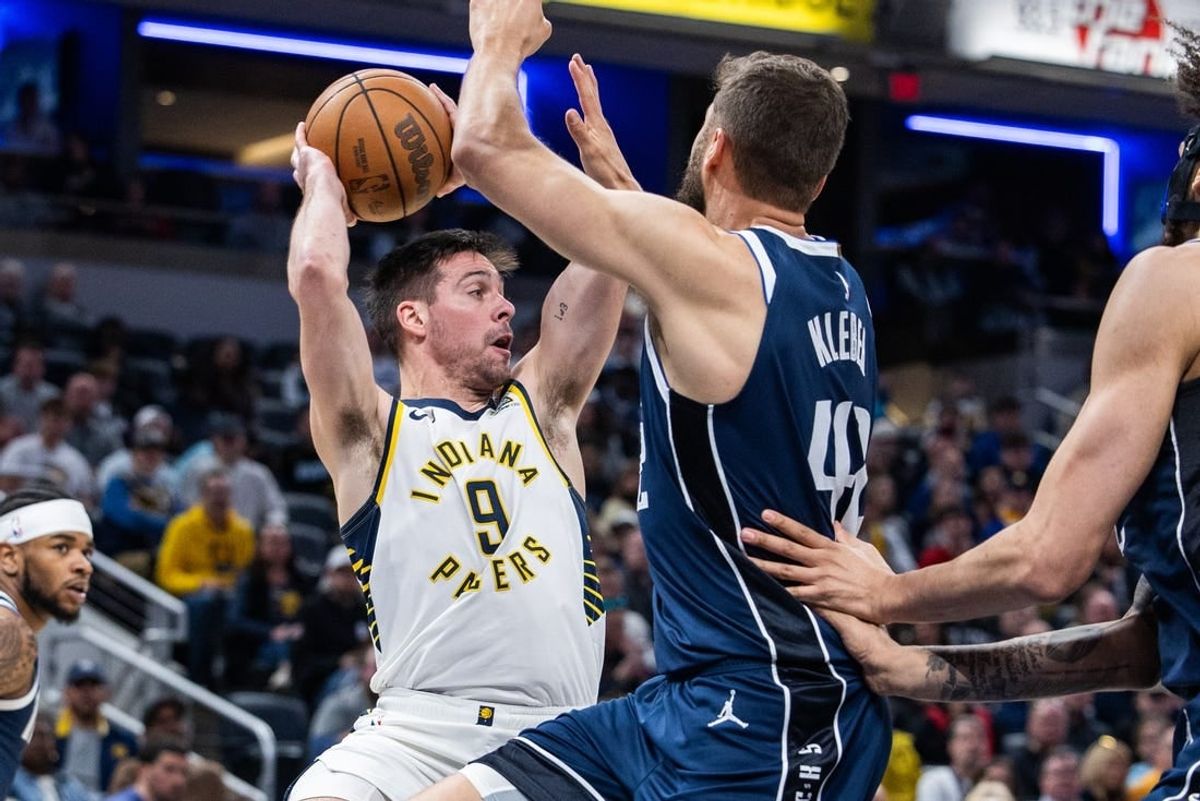 Feb 25, 2024; Indianapolis, Indiana, USA; Indiana Pacers guard T.J. McConnell (9) passes the ball while Dallas Mavericks forward Maxi Kleber (42) defends in the first half at Gainbridge Fieldhouse.