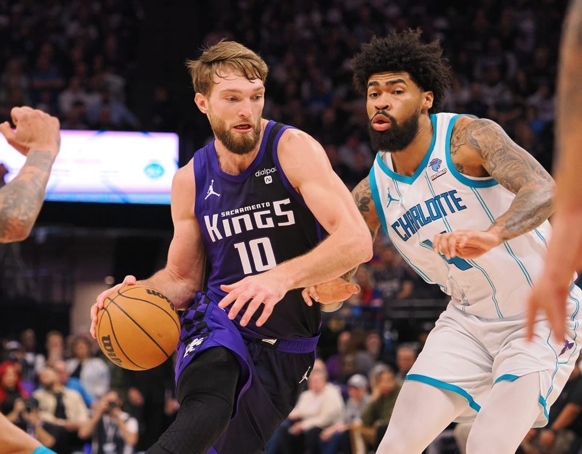 Jan 2, 2024; Sacramento, California, USA; Sacramento Kings center Domantas Sabonis (10) controls the ball against Charlotte Hornets center Nick Richards (4) during the second quarter at Golden 1 Center.
