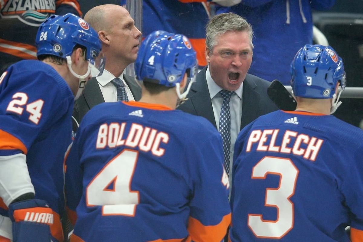 Jan 21, 2024; Elmont, New York, USA; New York Islanders head coach Patrick Roy talks to defensemen Scott Mayfield (24) and Samuel Bolduc (4) and Adam Pelech (3) during the first period against the Dallas Stars at UBS Arena.