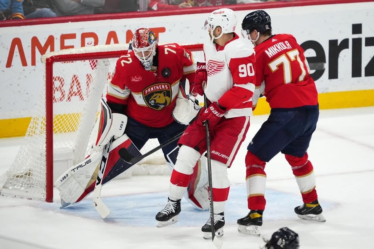 Jan 17, 2024; Sunrise, Florida, USA; Florida Panthers goaltender Sergei Bobrovsky (72) makes a save behind defenseman Niko Mikkola (77) and Detroit Red Wings center Joe Veleno (90) during the second period at Amerant Bank Arena.