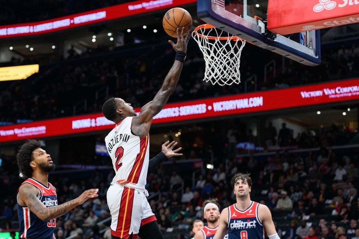 Mar 31, 2024; Washington, District of Columbia, USA; Miami Heat guard Terry Rozier (2) shoots a layup over Washington Wizards forward Marvin Bagley III (35) during the first quarter at Capital One Arena.