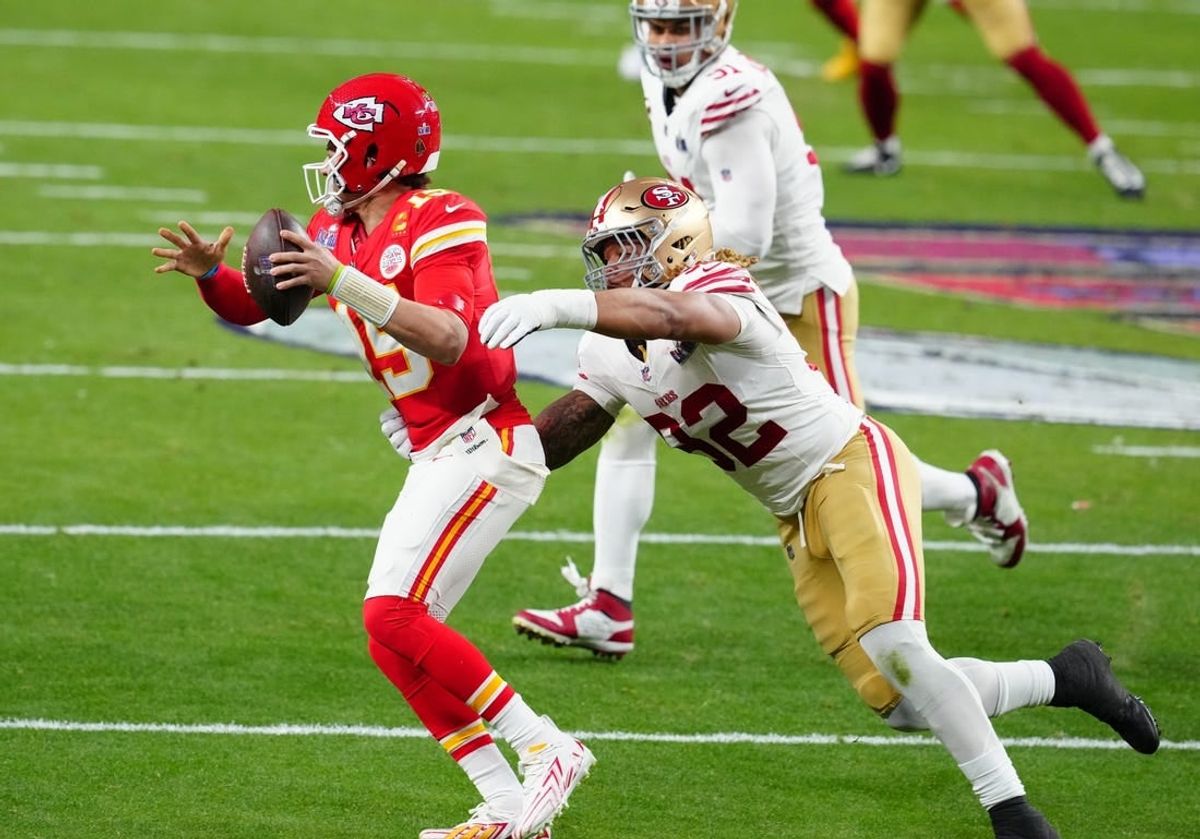 Feb 11, 2024; Paradise, Nevada, USA; Kansas City Chiefs quarterback Patrick Mahomes (15) is pressured by San Francisco 49ers defensive end Chase Young (92) in the first half in Super Bowl LVIII at Allegiant Stadium.