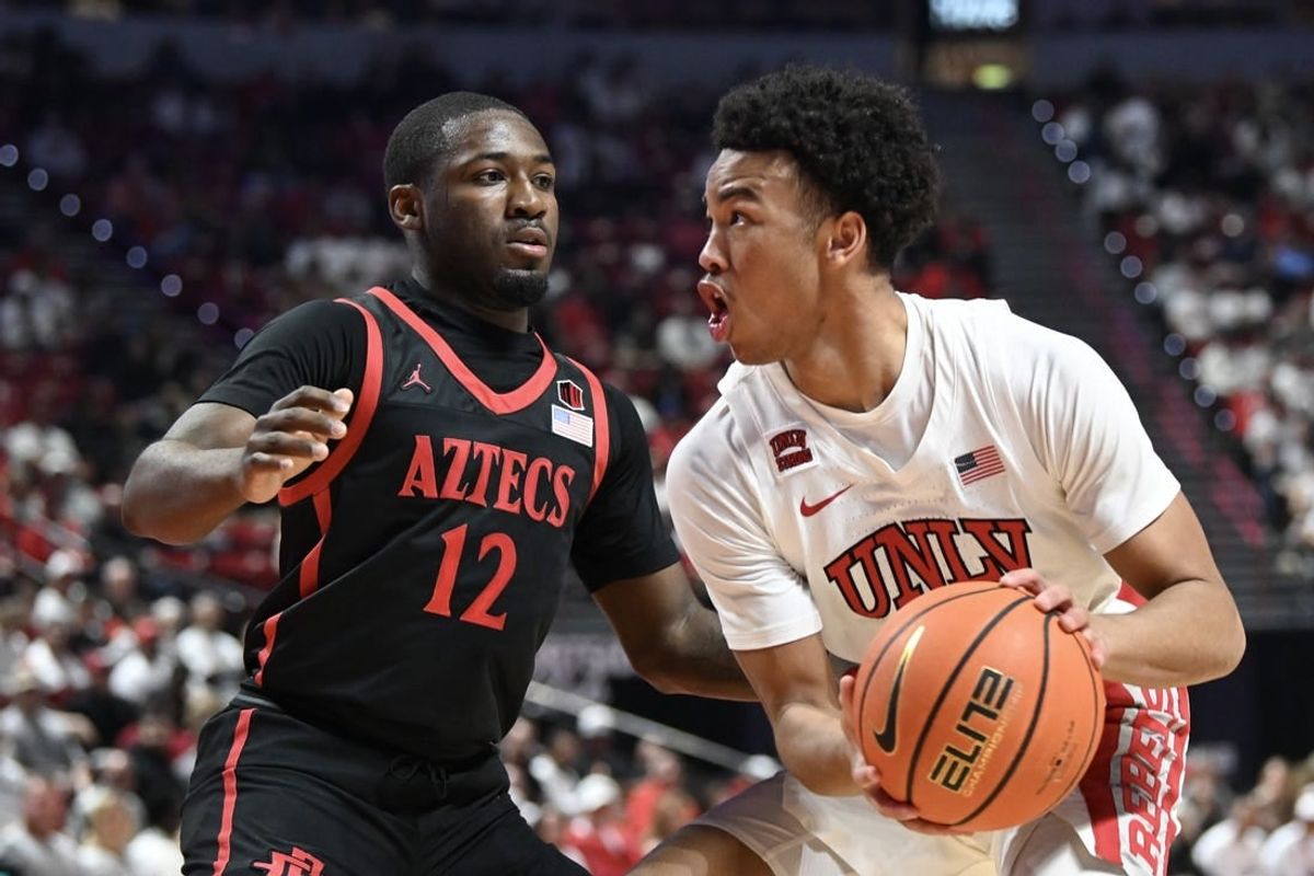 Mar 5, 2024; Las Vegas, Nevada, USA; San Diego State Aztecs guard Darrion Trammell (12) defends against UNLV Rebels guard Dedan Thomas Jr. (11) in the first half at Thomas & Mack Center.