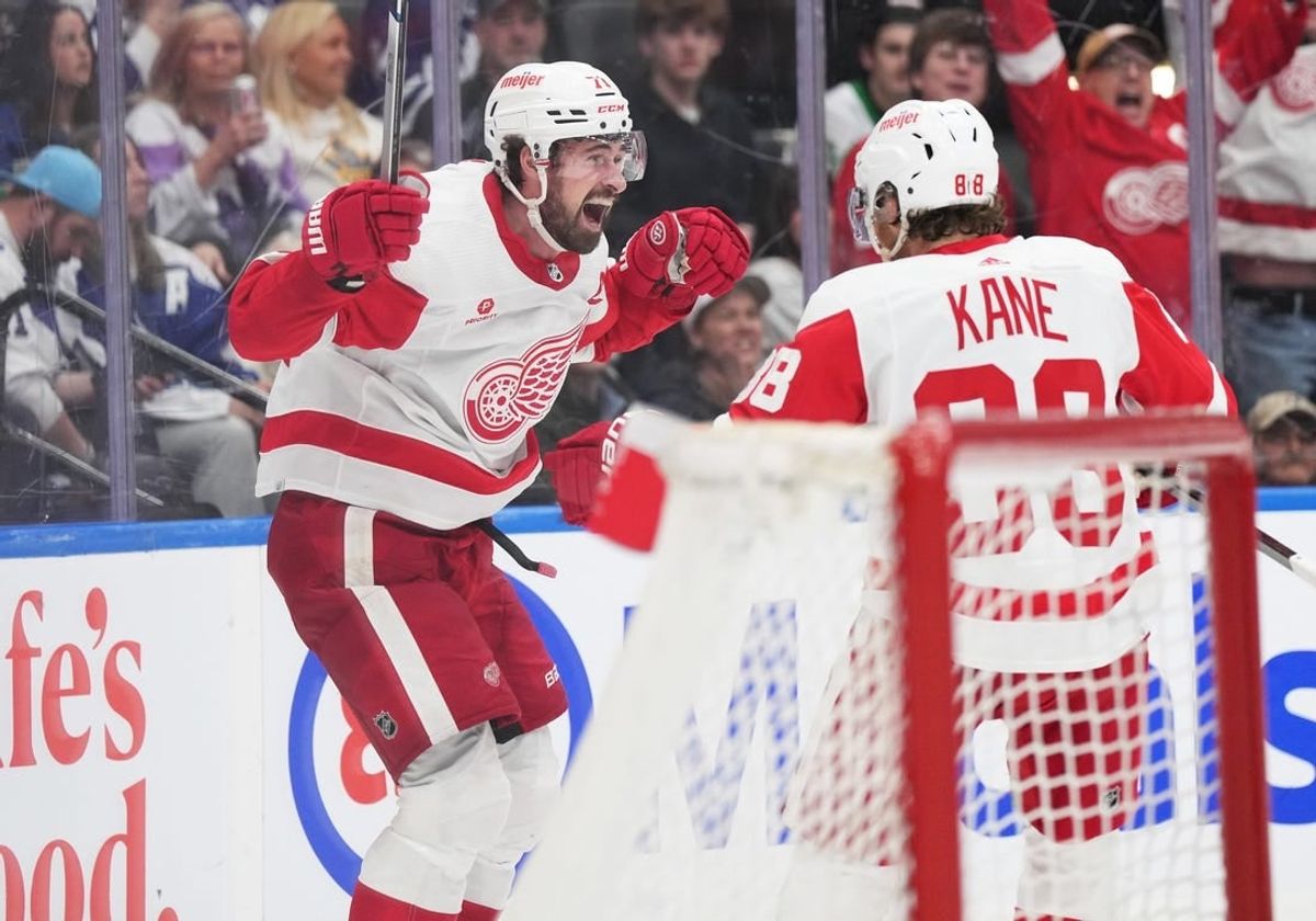 Apr 13, 2024; Toronto, Ontario, CAN; Detroit Red Wings center Dylan Larkin (71) scores the winning goal and celebrates with right wing Patrick Kane (88) against the Toronto Maple Leafs during the overtime period at Scotiabank Arena.