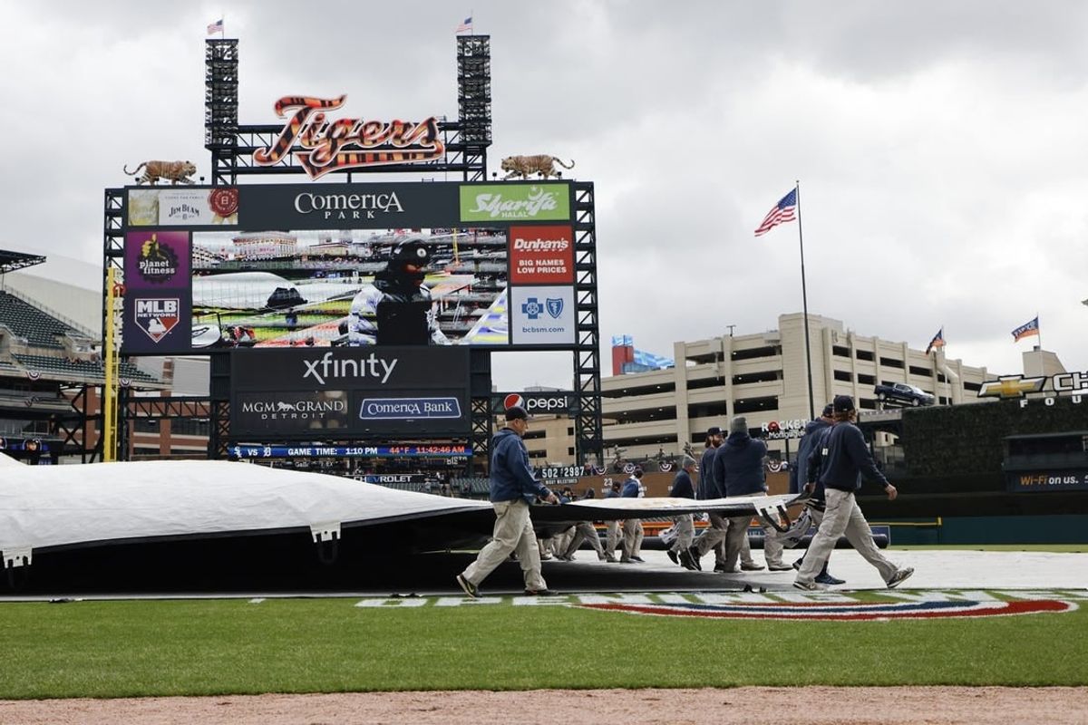 Apr 8, 2022; Detroit, Michigan, USA;  Grounds crew remove the tarp before the game between the Detroit Tigers and the Chicago White Sox at Comerica Park.
